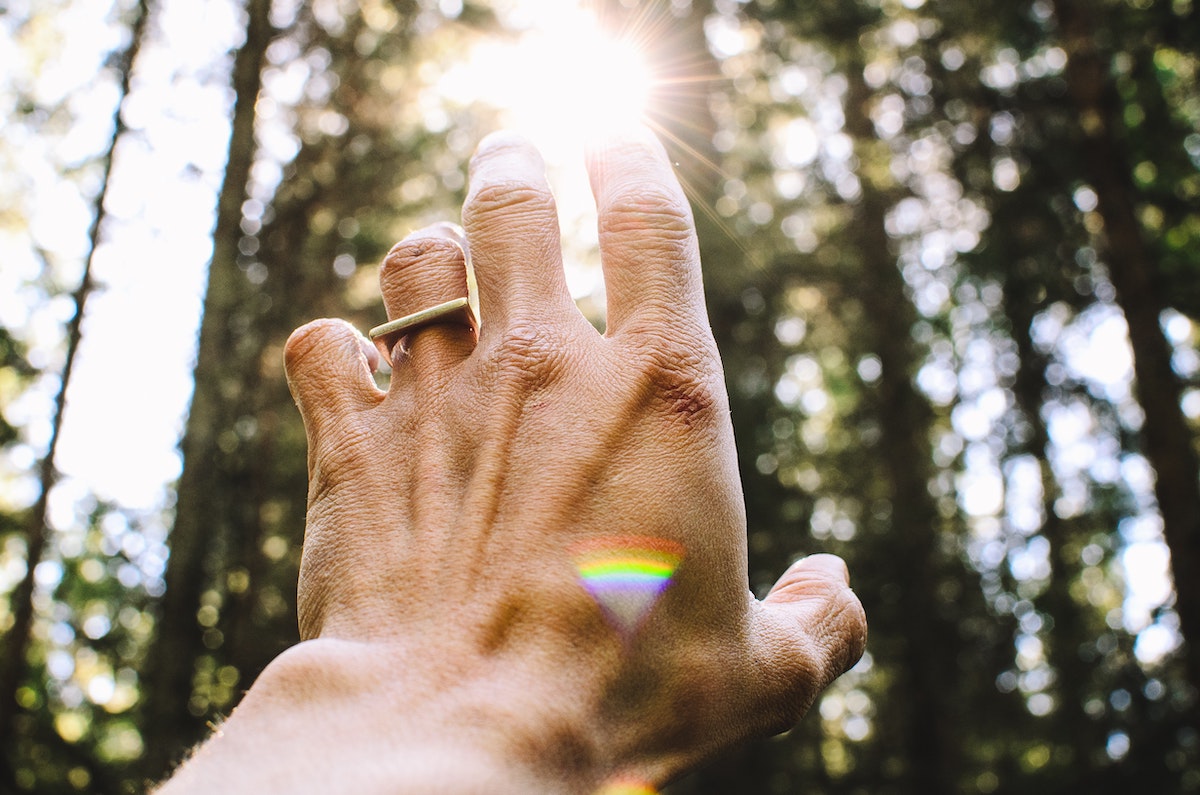 Man's hand reaching toward the light. You were created for intimacy.